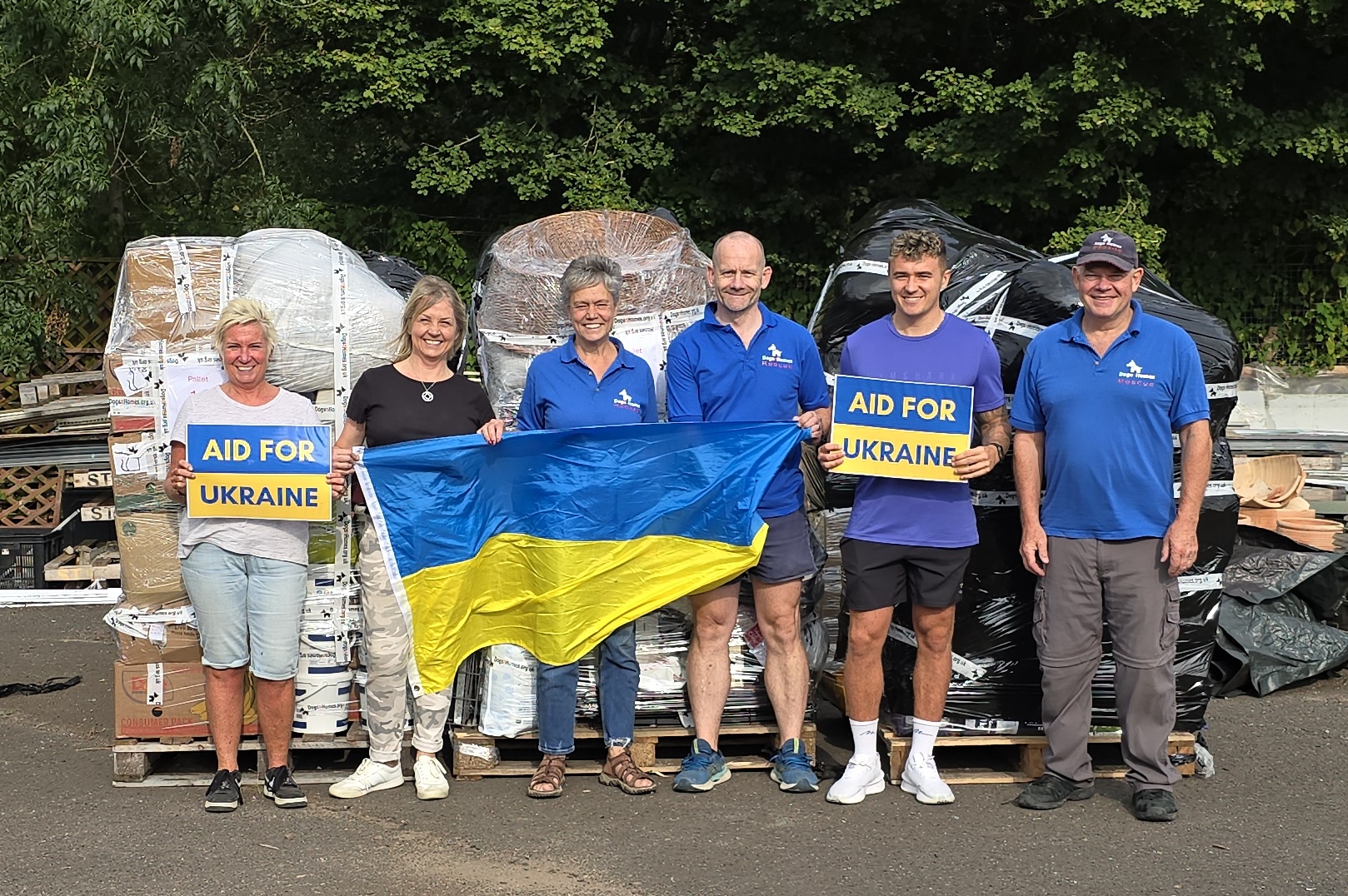 DogsnHomes Rescue Co-Founders Gary Baxter (far right) and Michelle Ballard (centre) with volunteer team packing pallets for Ukraine.  Credit - DNH Rescue