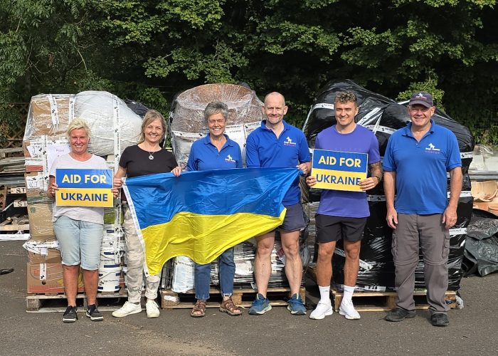DogsnHomes Rescue Co-Founders Gary Baxter (far right) and Michelle Ballard (centre) with volunteer team packing pallets for Ukraine.  Credit - DNH Rescue